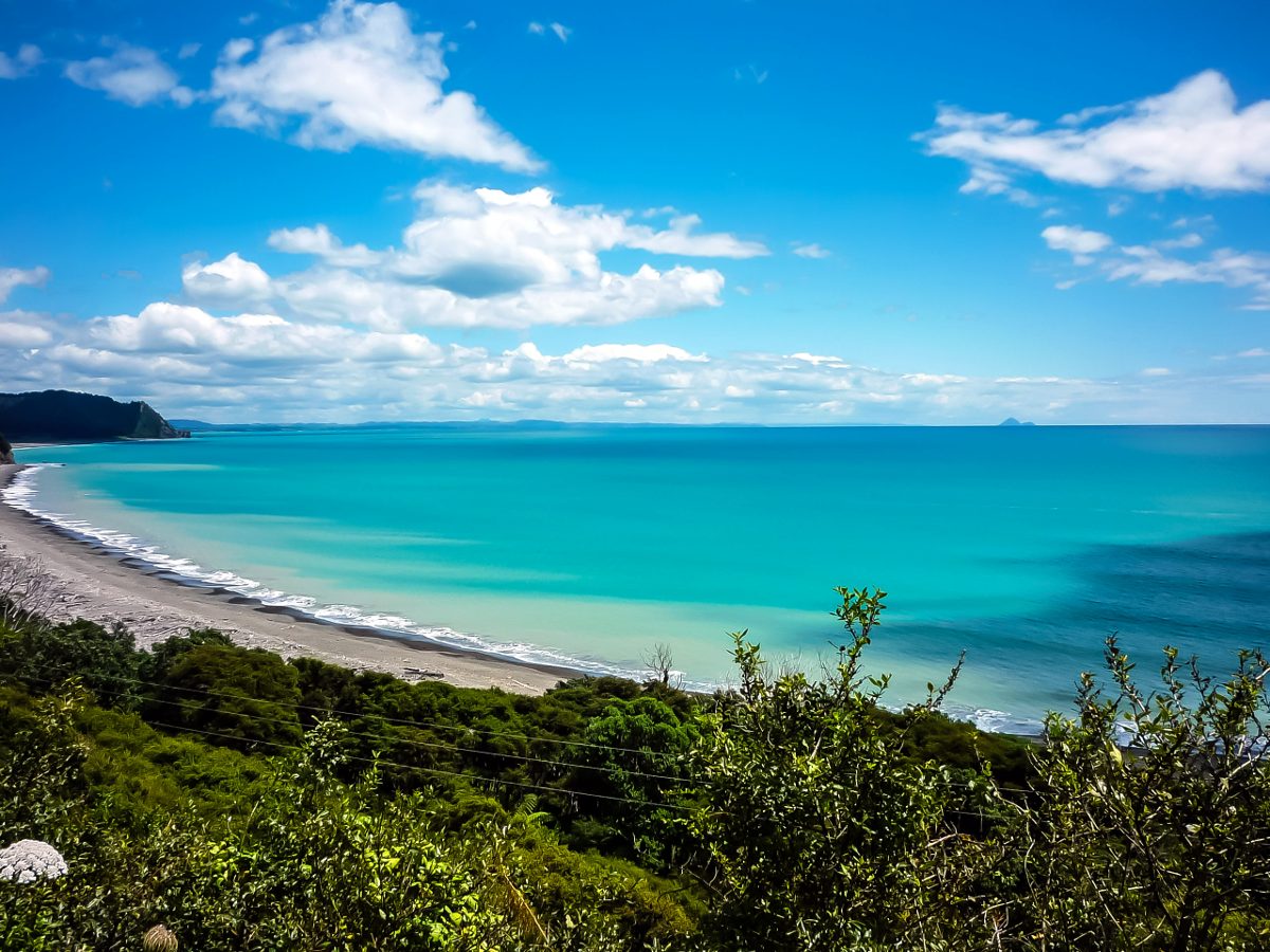 View of the ocean (green/blue coloured water) on a sunny day