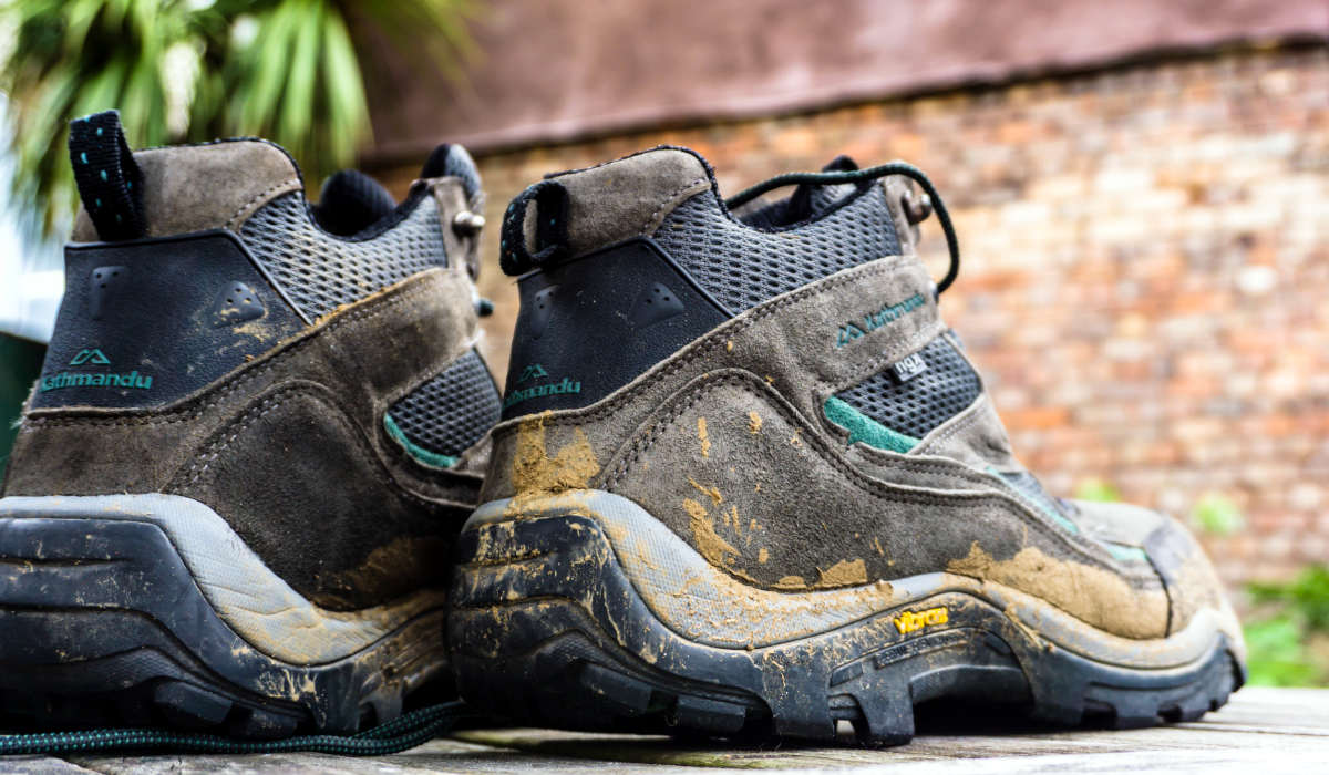 Close-up of a pair of dirty hiking boots - brand: Kathmandu