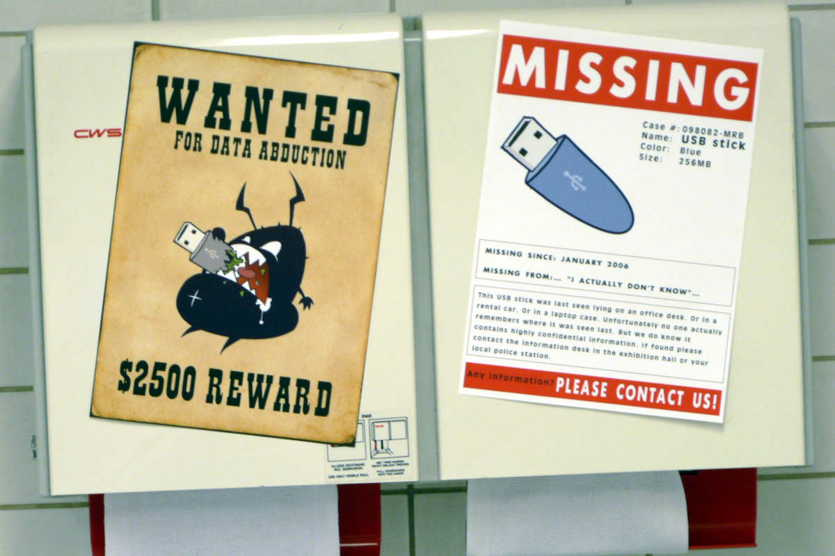 Two poster in WANTED and NEWS FLASH style on the paper towel machine of a public bathroom at an event