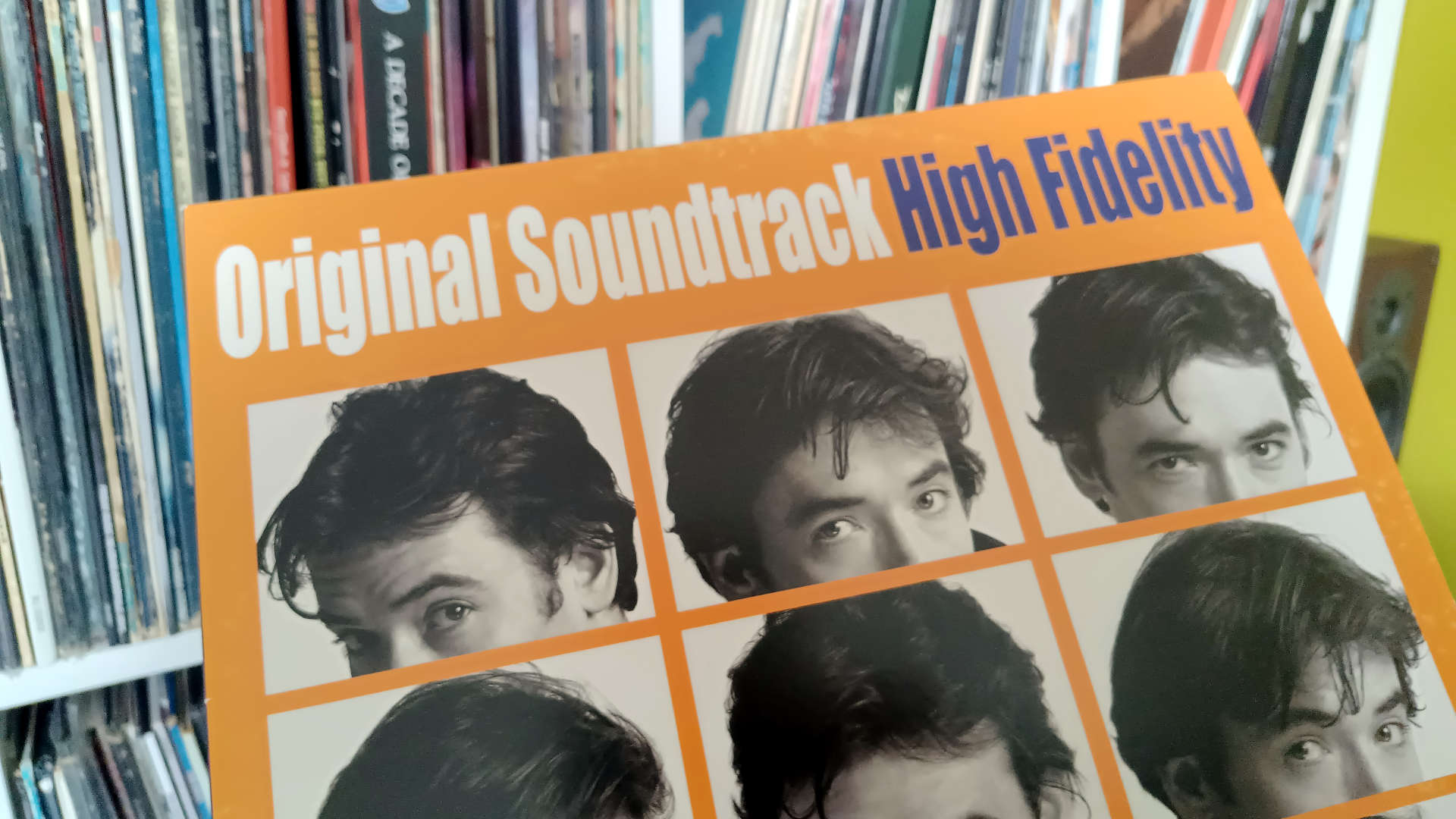 Cover of High Fidelity soundtrack on vinyl being pulled from the record collection