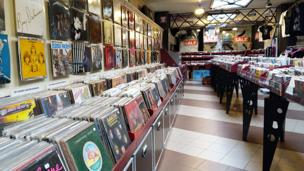 Record store in the Netherlands - photo of aisle and racks with records along the wall
